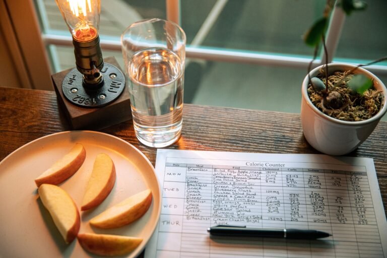 handwritten calorie counter food diary with apple slices and water